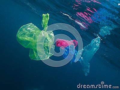 Colorful plastic bags floating in the ocean Stock Photo