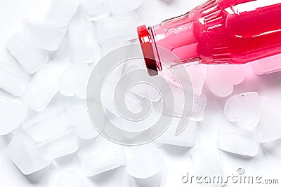 Colorful plastic bottles with ice cubes white desk background top view mockup Stock Photo