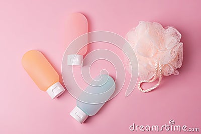 Colorful plastic containers for shampoo, hair balm and shower gel with washcloths. Cosmetic products for spa and bath accessories Stock Photo