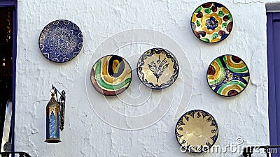 Colorful plates hanging on a wall Stock Photo
