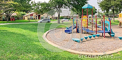 Colorful playground in green park near residential area in Richardson, Texas, USA Editorial Stock Photo