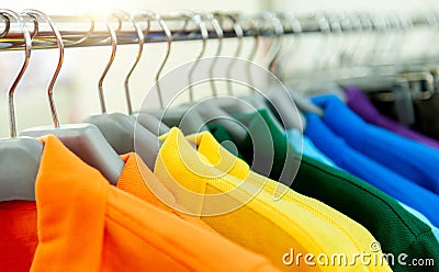 Colorful polo shirts on hangers Stock Photo