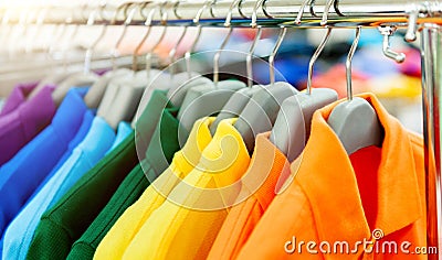 Colorful polo shirts on hangers Stock Photo