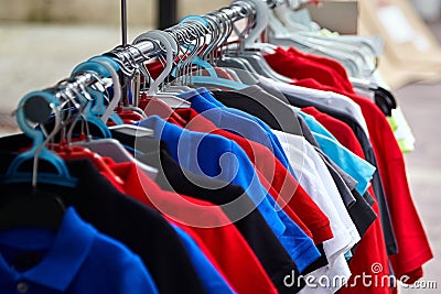 Colorful polo t-shirt for the man on hangers in shop Stock Photo