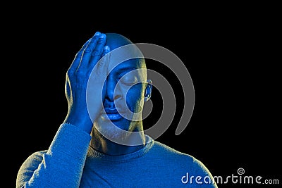 Colorful portrait of a black man. One eye covered with the hand Stock Photo