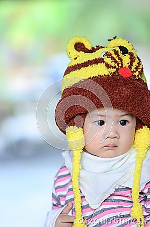 colorful portrait of cute baby boy dressed in lion custume,looking for something on blurry background. Stock Photo