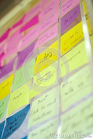 Colorful post it on glass wall Stock Photo