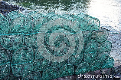 Colorful prawn traps piled on a dock in western Scotland Stock Photo