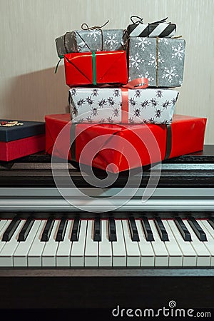 Colorful present boxes on the piano. Christmas decoration of Interior. Stock Photo
