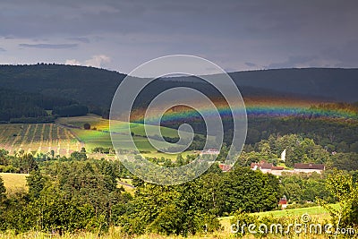 Colorful rainbow over mountains Stock Photo