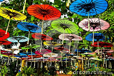 Colorful rainbow paper umbrella hanging in the sky Stock Photo