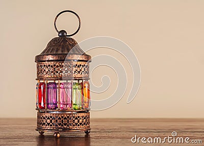 Colorful Ramadan lantern fanos on a wooden table Stock Photo