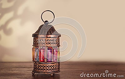 Colorful Ramadan lantern fanos on a wooden table Stock Photo