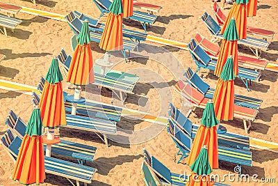 Colorful reclining chairs and parasols on a beach seen from above Stock Photo