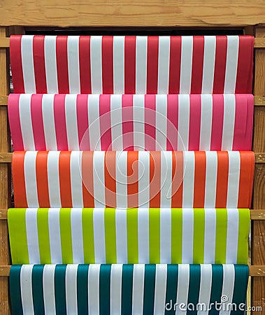 Colorful Red, Pink, Orange, Green and Blue Stripe Pattern Paper on Wooden Shelf for DIY Work Stock Photo
