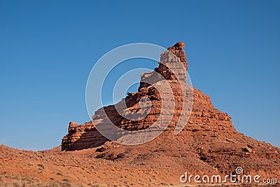 Colorful red rock formations contrast against a stark blue sky - Valley of the Gods Utah Stock Photo