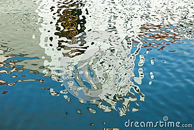 Colorful reflections on the sea water. Abstract background. Stock Photo