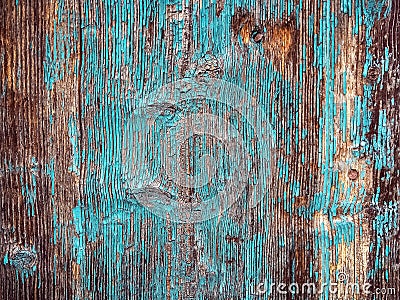 Colorful rough wood texture: old rustic house wall covered with bright turquoise peeling paint. Stock Photo