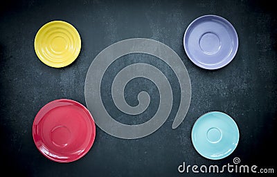 Colorful round dishes on dark blue background Stock Photo