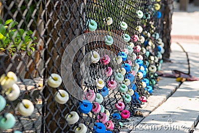 Colorful and round soft decorations on the net fence Stock Photo