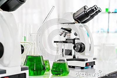 Colorful rows of laboratory or classroom test tubes and microscope with metal lens, Science and education. Scientific experiment, Stock Photo