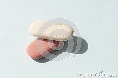 Colorful rubber erasers on a blue background. Stock Photo