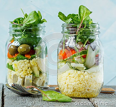 Colorful salad with couscous, tofu and vegetables in a jar. Stock Photo