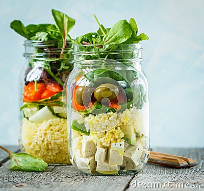 Colorful salad with couscous, tofu and vegetables in a jar. Stock Photo