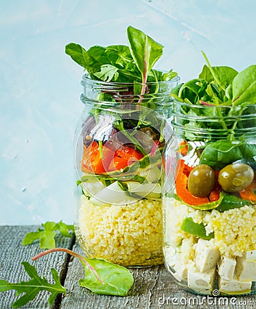 Colorful salad with couscous, tofu and vegetables in a jar. Stock Photo