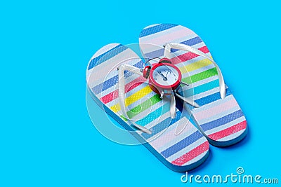 Colorful sandals and cute small alarm clock on the wonderful blu Stock Photo