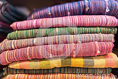 Colorful scarves, shawl or wrap at a store shelf. Colors of fashion textiles, A beautiful accessory complementing the Stock Photo