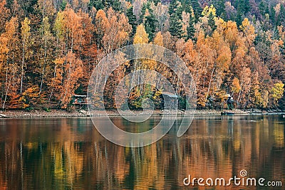 Colorful scenic autumn forest reflects in the water Stock Photo