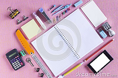 Colorful School Supplies Organized by Type Around Note Book Open to Blank Page Arranged Stock Photo