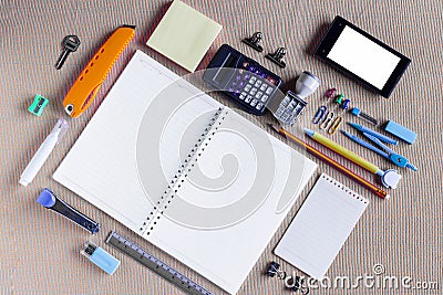 Colorful School Supplies Organized by Type Around Note Book Open to Blank Page Arranged Stock Photo