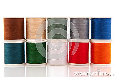 Colorful sewing threads on white spools Stock Photo