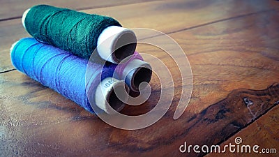 Colorful sewing threads on wood background Stock Photo