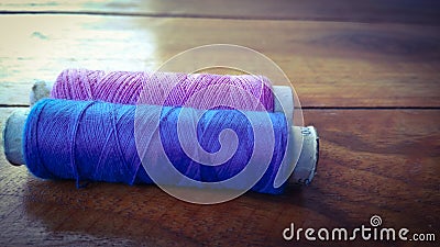 Colorful sewing threads on wood background Stock Photo