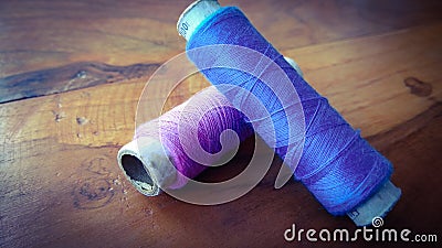 Colorful sewing threads on wood background Stock Photo