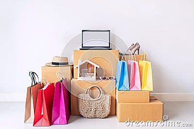 Colorful shopping bag with stack of cardboard boxes and fashion items at home, Website online shopping concept Stock Photo