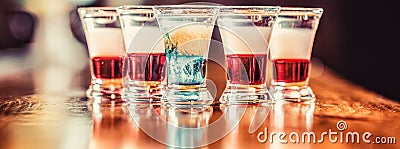 Colorful shots at the club. Alcoholic drink in different colors. Tequila shots, vodka, whisky. Set of alcoholic Stock Photo