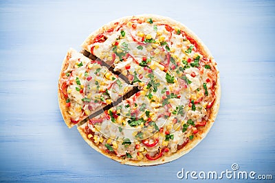 Colorful sliced pizza with mozzarella cheese, chicken, sweet corn, sweet pepper and parsley top view Stock Photo