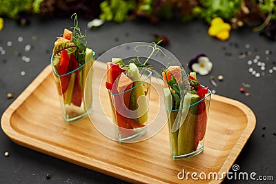 Colorful slices of raw vegetables in glasses carrots, cucumber, sweet pepper. The concept of diet, healthy and vegetarian food Stock Photo