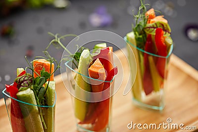 Colorful slices of raw vegetables in glasses carrots, cucumber, sweet pepper. The concept of diet, healthy and vegetarian food Stock Photo