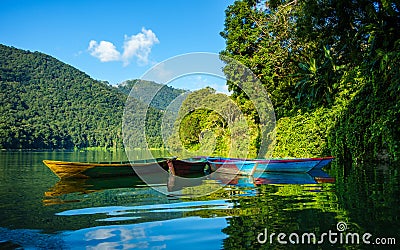 Colorful small boats on Phewa Lake in Pokhara Stock Photo