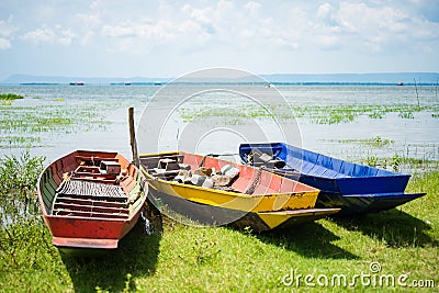 Colorful small fishing boats with anchor stones to stabilize and Stock Photo