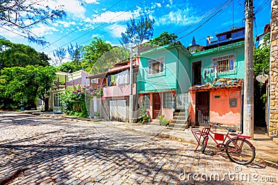 Colorful small houses along a cobbled street in Buzios, Brazil Stock Photo