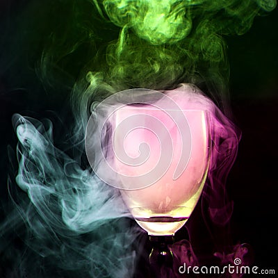 Colorful smoke in the cocktail glass Stock Photo