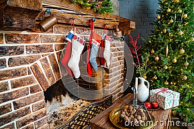 socks for a gift from Santa Claus hang on the fireplace. a large christmas tree Stock Photo