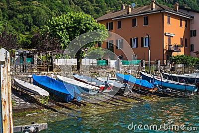 Colorful speed boats in Brusino Arsizio moored on the shore of Lake Lugano, in Switzerland. Editorial Stock Photo