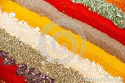 Colorful spice background with different color spices, macro. Various spices arranged in rows. Abstract textured background Stock Photo